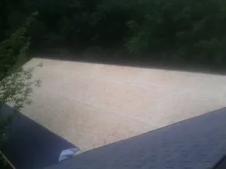 New OSB roof sheathing installed beside an existing shingle roof in North Bonneville
